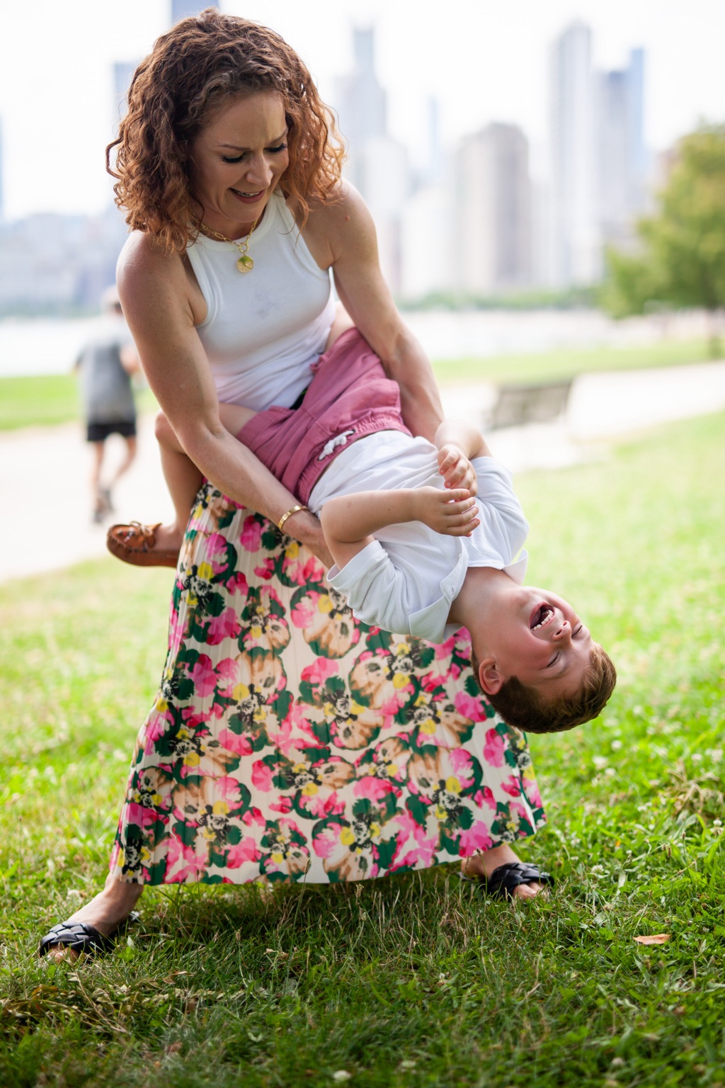 Portrait of a mother swinging her son