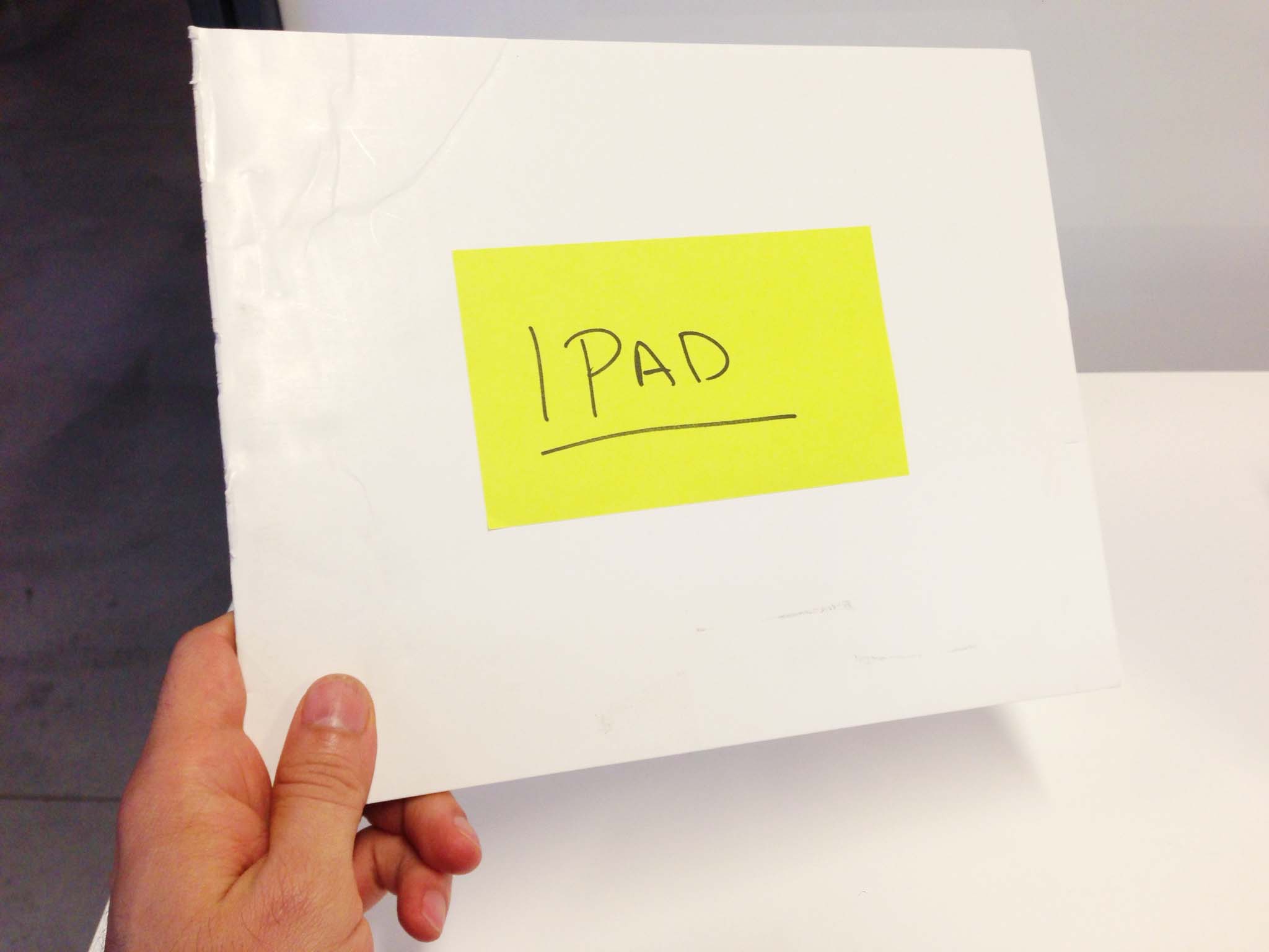 Photo of a small scrap of foam core board cut to the size of an iPad. There's a Post-It stuck to it, with the word 'iPad' written on it.